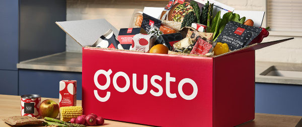 Red Gousto box with food inside on a wooden table
